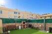 Well-maintained courtyard with artificial grass, grill fireplace and bench in ground floor apartment, Palma de Mallorca