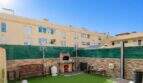 Well-maintained courtyard with artificial grass, grill fireplace and bench in ground floor apartment, Palma de Mallorca