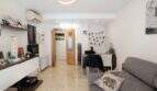 Bright living room with designer lamp, marble floors, gray sofa and modern TV area in ground floor apartment Palma