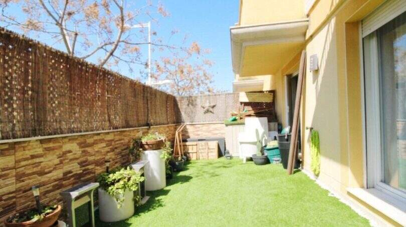 Well-maintained garden area with artificial grass and privacy screen of a ground floor apartment in Palma de Mallorca