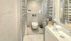 Modern bathroom of the Meereslinie apartment in Palmanova with shower, suspended toilet and light-colored wash basin