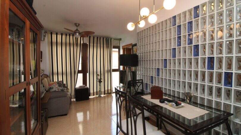 Living-dining area with glass block wall, modern pendant light and ceiling fan in Palma de Mallorca