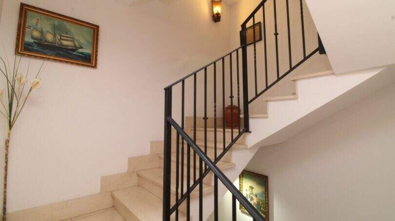 Elegant stairwell with marble steps and black iron railing in a building in Palma de Mallorca
