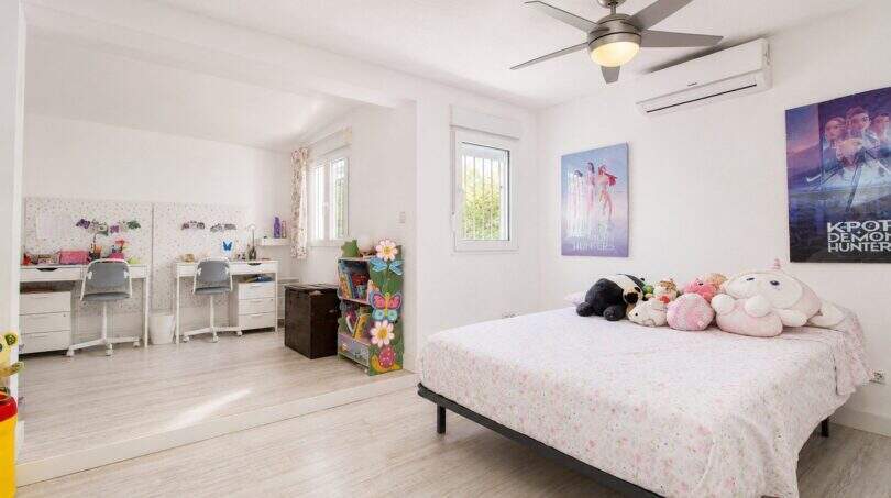 Helles Kinderzimmer mit Doppelbett, Schreibtischen, Spielzeug und Klimaanlage in Finca bei Palma de Mallorca.
