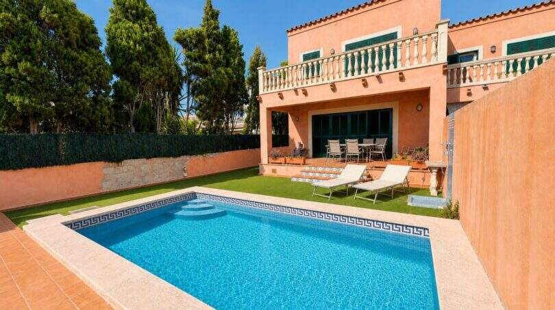Elegant pool area with surrounding sun terrace and private garden area