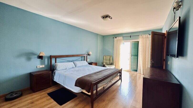 Comfortable master bedroom with direct terrace access and high-quality furnishings