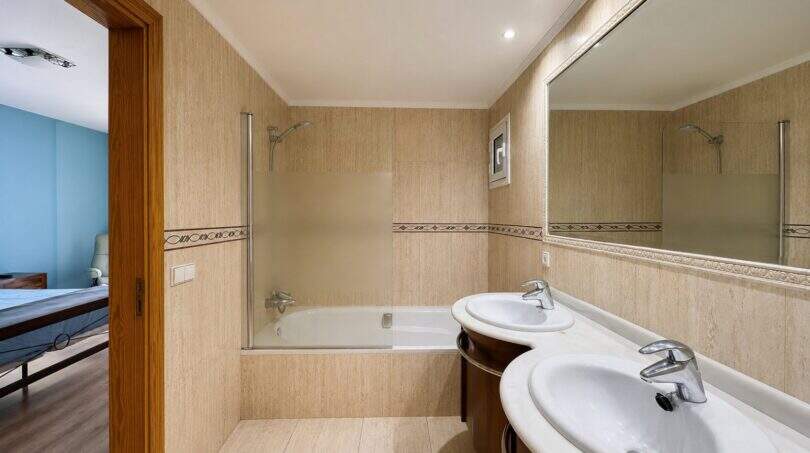Luxurious bathroom with double vanity, walk-in shower and large mirror