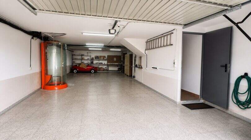 Functional garage with comprehensive storage solution and practical ancillary rooms