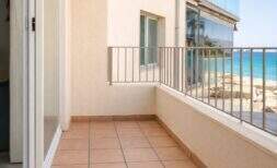 Geräumiger Balkon mit Terrakottafliesen und Meerblick in stilvoller Stadtwohnung in Palma de Mallorca.