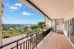 Large balcony with tiled floors, view of palm trees, Paseo Marítimo and Palma de Mallorca yacht harbor