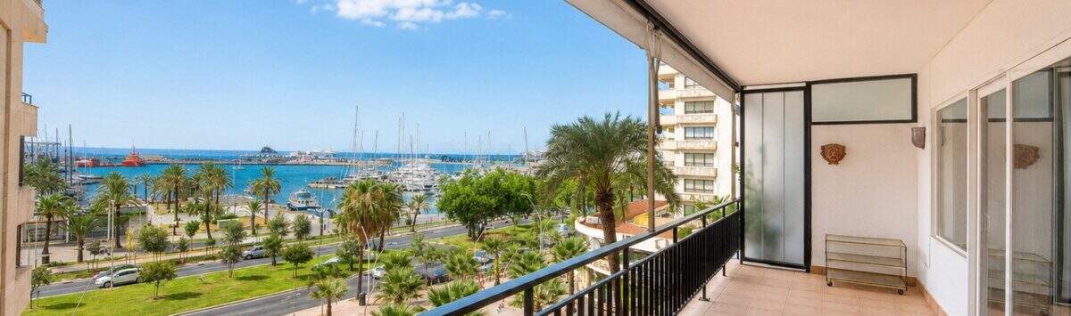 Large balcony with tiled floors, view of palm trees, Paseo Marítimo and Palma de Mallorca yacht harbor