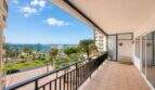 Large balcony with tiled floors, view of palm trees, Paseo Marítimo and Palma de Mallorca yacht harbor