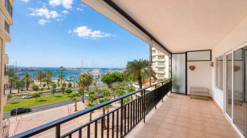 Large balcony with tiled floors, view of palm trees, Paseo Marítimo and Palma de Mallorca yacht harbor