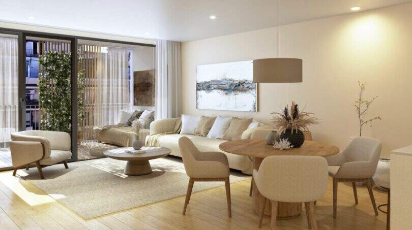 Bright living room with dining area, balcony and modern interior in the new construction project Palma de Mallorca