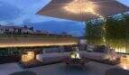 Elegant Roof Terrace with Lounge Furniture, Sunshade, and Atmospheric Lighting in New Development Project Palma
