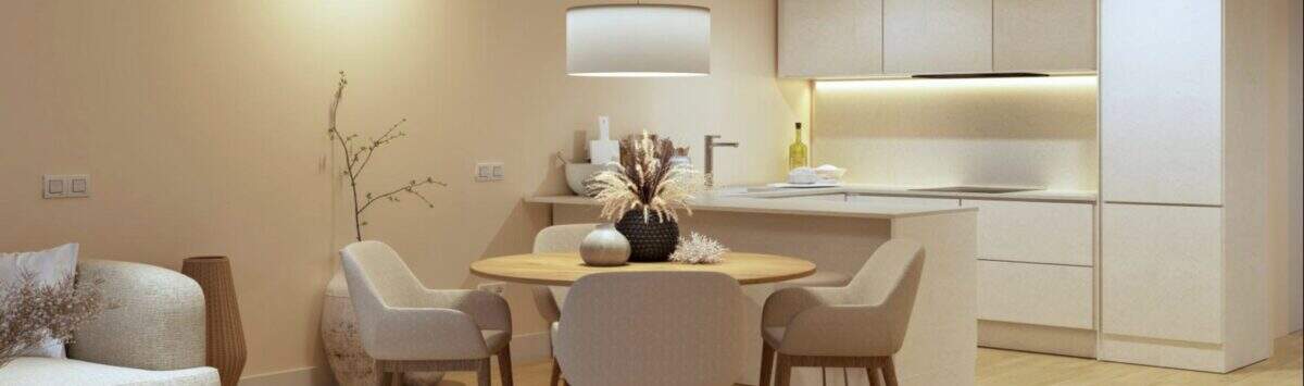 Bright living-dining room with wooden table, modern kitchen and warm design in new building Palma de Mallorca