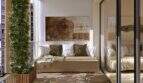Sunny balcony with natural materials, sofa, artwork and vertical greenery element in the new Palma building
