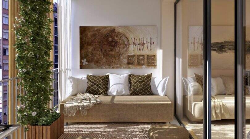 Sunny balcony with natural materials, sofa, artwork and vertical greenery element in the new Palma building