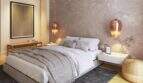 Elegant bedroom with double bed, copper pendant lights and concrete wall in the new Palma de Mallorca building