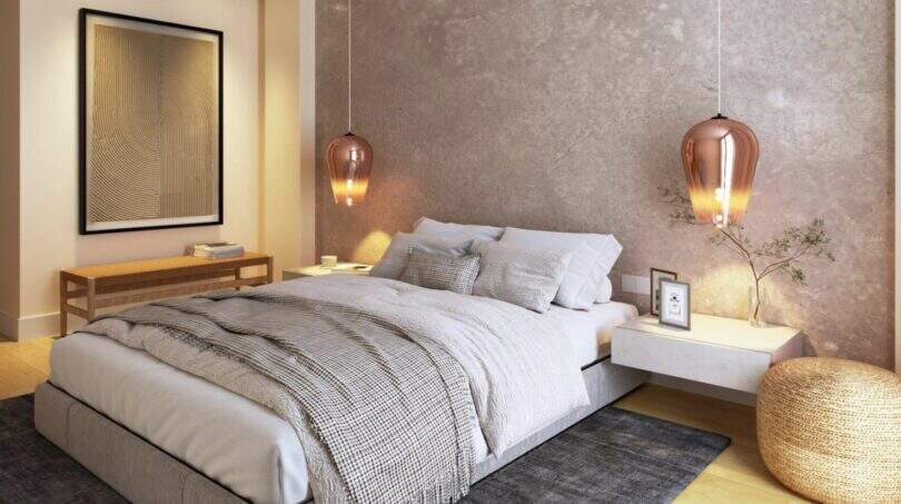 Elegant bedroom with double bed, copper pendant lights and concrete wall in the new Palma de Mallorca building