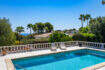 Private pool with white balustrade, sea view and palm trees in Villa Cala Murada