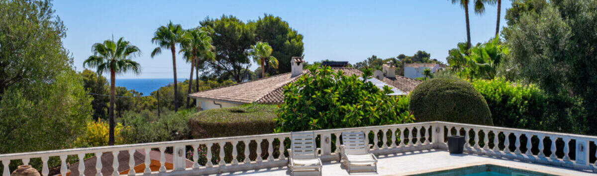 Private pool with white balustrade, sea view and palm trees in Villa Cala Murada