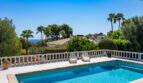 Private pool with white balustrade, sea view and palm trees in Villa Cala Murada