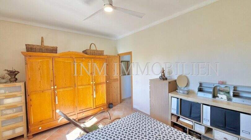 Schlafzimmer der Finca bei Algaida mit Holzschrank, Deckenventilator und Terrakottaboden