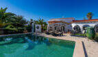 Outdoor area of the sea view villa in Cala Murada with turquoise pool, sun loungers and Mediterranean garden ambience