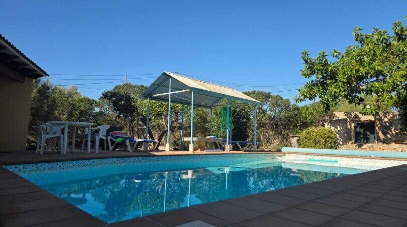 Cala Millor finca: Blue pool with gazebo, sun loungers and lush greenery under sunny sky.