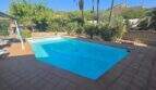 Private pool with blue water, palms and mountain panorama of the finca in Cala Millor