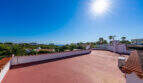 Sunny roof terrace of the sea view villa in Cala Murada with wide panoramic views of sea and palm trees.