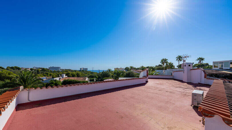 Sunny roof terrace of the sea view villa in Cala Murada with wide panoramic views of sea and palm trees.