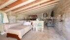 Rustic storage room with wooden beamed ceiling and brick vault of the finca in Son Carrió, Mallorca.