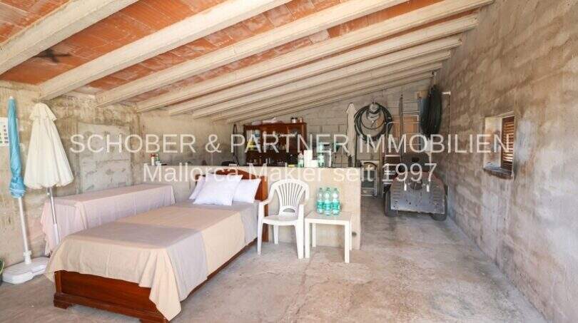 Rustic storage room with wooden beamed ceiling and brick vault of the finca in Son Carrió, Mallorca.
