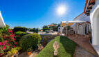 Sunny outdoor terrace of the sea view villa in Cala Murada with pergola, bougainvillea and well-maintained garden