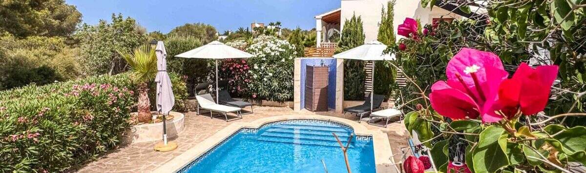 Privater Pool mit Sonnenterrasse, Liegestühlen und üppigem Garten einer exklusiven Villa in Santanyí