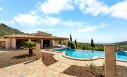 Outdoor area of the finca in Cala Murada with large swimming pool, natural stone terrace and sea view.