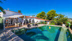 Outdoor area of the sea view villa in Cala Murada with turquoise pool, sun terrace and white Mediterranean architecture.