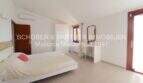 Bright master bedroom of the Mallorca finca with double bed, desk, wardrobe and terrace access.