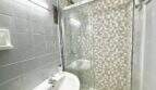 Bathroom with glass shower and sink, needing renovation, apartment Playa de Palma Mallorca