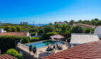 View from the roof of the pool with sun loungers and sea view of the villa in Cala Murada