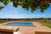Outdoor area of the finca in Son Carrió with rectangular pool, natural stone terrace, sun lounger and view over fields.