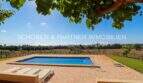 Outdoor area of the finca in Son Carrió with rectangular pool, natural stone terrace, sun lounger and view over fields.