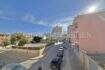Street view of the apartment in Ses Cadenes, Palma de Mallorca, overlooking a busy street and sunny sky.