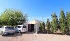 Gravel parking space with garage, cypress trees and deciduous trees on Mallorca finca in Son Carrió.