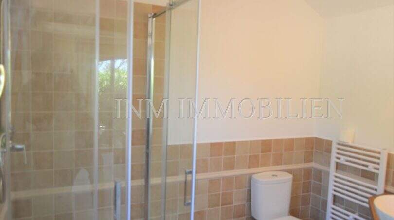 Badezimmer mit Glasdusche, WC und Handtuchheizkörper im Landhaus Llucmajor