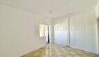 Empty living space with checkerboard tile floor in apartment needing renovation at Playa de Palma