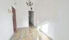 Bright hallway with checkerboard tile floor and chandelier in apartment needing renovation, Playa de Palma
