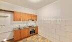 Kitchen needing renovation with wooden base cabinets, built-in stove, tile backsplash and checkerboard floor in Ses Cadenes.